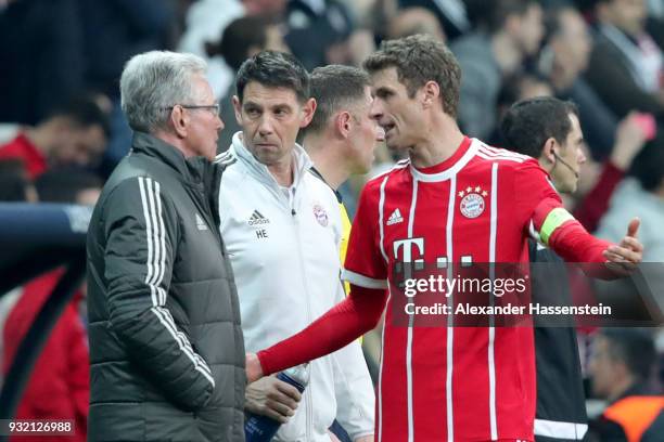 Jupp Heynckes, head coach of Bayern Muenchen talks to his player Thomas Mueller during the UEFA Champions League Round of 16 Second Leg match...
