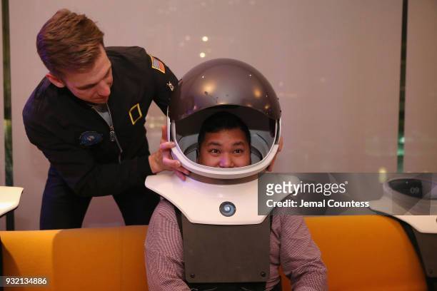 Guests try out rear-projection space helmets at National Geographics world premiere screening of One Strange Rock on Wednesday, March 14, 2018 in...
