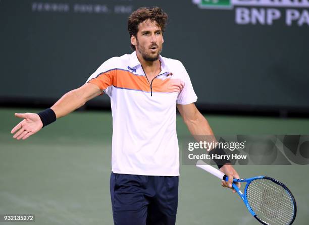 Feliciano Lopez of Spain reacts after a lost point in his match against Sam Querrey of the United States during the BNP Paribas Open at the Indian...