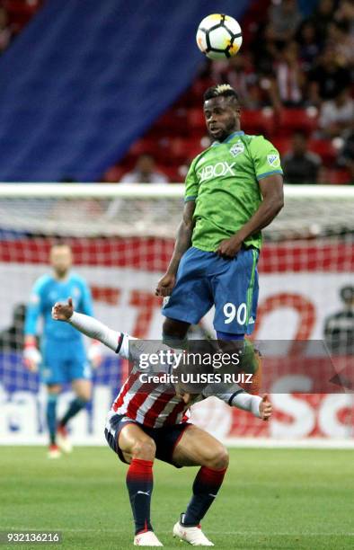 Mexican Guadalajara's midfielder Isaac Brizuela vies for the ball with US Seattle Sounders defender Waylon Francis during their second leg match of...