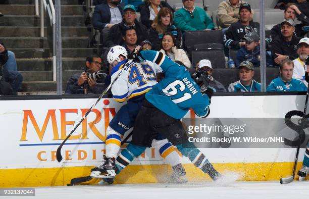 Justin Braun of the San Jose Sharks and Ivan Barbashev of the St. Louis Blues battle for the puck at SAP Center on March 8, 2018 in San Jose,...