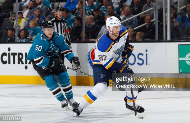 Alex Pietrangelo of the St. Louis Blues skates with the puck against Chris Tierney of the San Jose Sharks at SAP Center on March 8, 2018 in San Jose,...