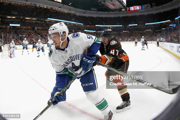 Hampus Lindholm of the Anaheim Ducks defends against Alex Biega of the Vancouver Canucks during the first period of a game at Honda Center on March...