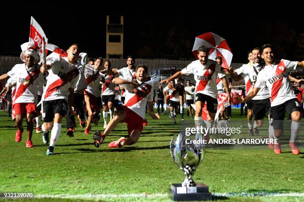 River Plate's players celebrate after winning the Supercopa Argentina 2018 after defeating Boca Juniors in the final football match at Malvinas...