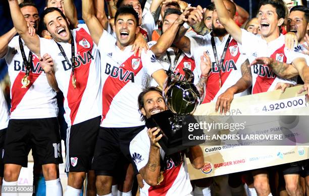 River Plate's Leonardo Ponzio rises the trophy of the Supercopa Argentina 2018 after defeating Boca Juniors in the final football match at Malvinas...