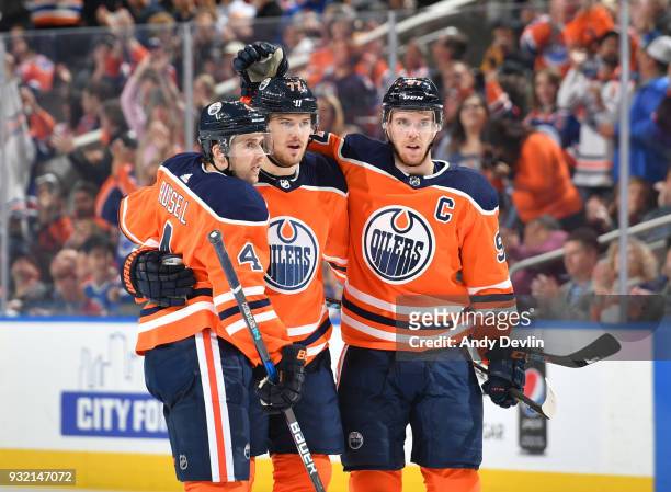 Kris Russell, Oscar Klefbom and Connor McDavid of the Edmonton Oilers celebrate after a goal during the game against the San Jose Sharks on March 14,...