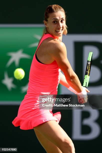 Petra Martic of Croatia returns a shot to Simona Halep of Romania during the BNP Paribas Open at the Indian Wells Tennis Garden on March 14, 2018 in...