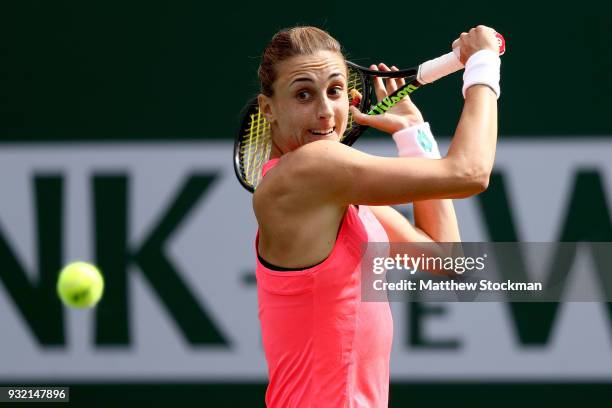 Petra Martic of Croatia returns a shot to Simona Halep of Romania during the BNP Paribas Open at the Indian Wells Tennis Garden on March 14, 2018 in...