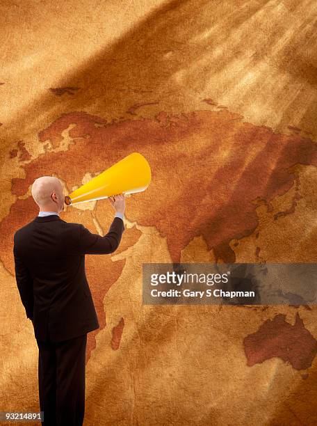 businessman with megaphone speaking to world - eastern hemisphere stock pictures, royalty-free photos & images