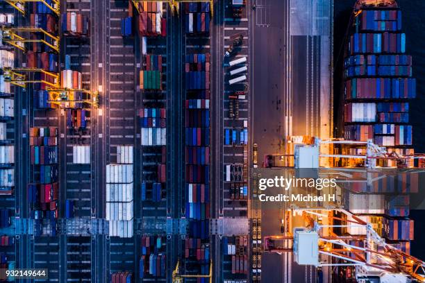 aerial view of cranes and containers in  port. - night delivery stock pictures, royalty-free photos & images