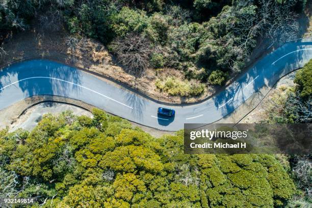 aerial view of road amidst trees in forest. - movendo um veículo - fotografias e filmes do acervo