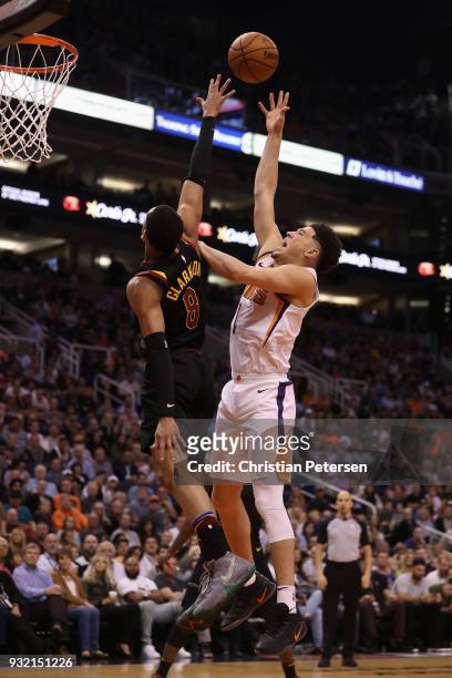 Devin Booker of the Phoenix Suns puts up a shot over Jordan Clarkson of the Cleveland Cavaliers during the second half of the NBA game at Talking...