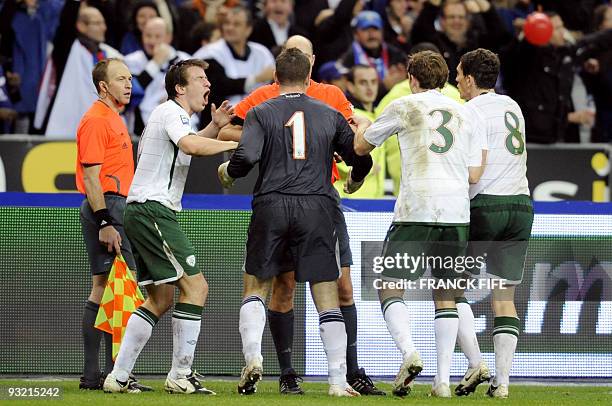 Irish national football team goalkeeper Shay Given , defender Richard Dunne, and midfielder Keith Andrews speak with Swedish referee Martin Hansson...