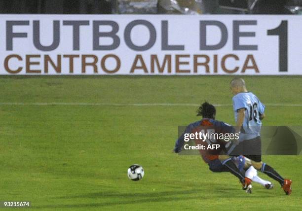Costa Rica's midfielder Junior Diaz is fouled by Uruguay's midfielder Maximiliano Pereira during their FIFA World Cup South Africa 2010 qualifier...