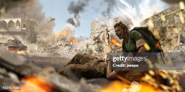 female soldier medic helping injured female soldier in war zone - horror of war stock pictures, royalty-free photos & images