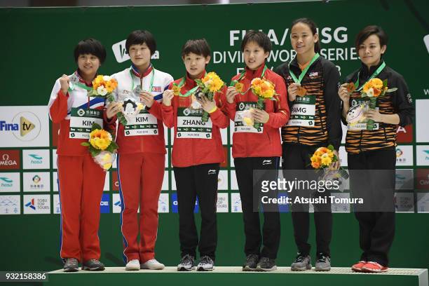 Mi-Rae Kim and Kuk-Hyang Kim of North Korea , Jiaqi Zhang and Minjie Zhang of China and Jun Hoong Cheong and Pandelela Pamg of Malaysia pose on the...