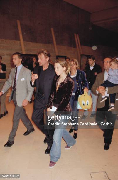 Johnny Hallyday with his daughter Laura Smet arriving at the fashion show. Françoise Thibaut, her husband and daughter Margaux Thibaut are...