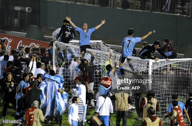 Uruguay's midfielder Diego Perez and Uruguay's midfielder Alvaro Fernandez celebrate their ticket to South Africa at the end of the FIFA World Cup...