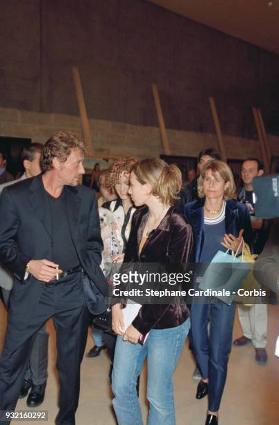 Johnny Hallyday with his daughter Laura Smet and his wife Laeticia Hallyday arriving at the fashion show. Laeticia Hallyday is accompanied by her...