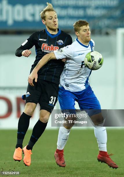 Ben Zolinski of Paderborn and Andre Hainault of Magdeburg battle for the ball during the 3. Liga match between SC Paderborn 07 and 1. FC Magdeburg at...