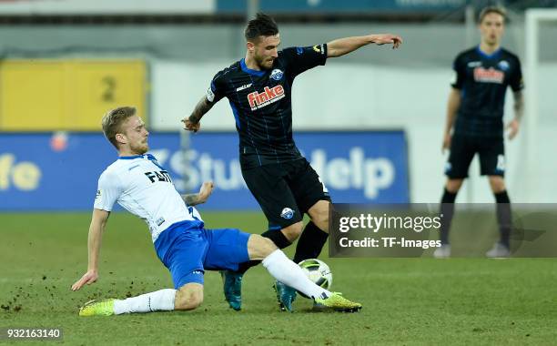 Nils Butzen of Magdeburg and Robin Krausse of Paderborn battle for the ball during the 3. Liga match between SC Paderborn 07 and 1. FC Magdeburg at...