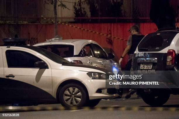 Rio's Civil Police officers investigate at Brazilian politician Marielle Franco's car, where she was found shot dead in Rio de Janeiro, Brazil on...