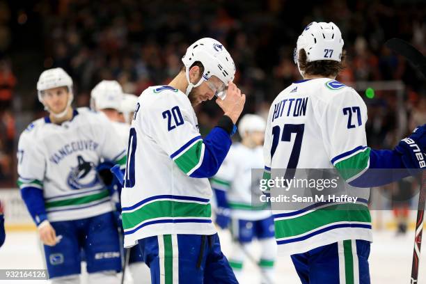 Brandon Sutter and Ben Hutton of the Vancouver Canucks look on after a goal by Brandon Montour of the Anaheim Ducks during the third period of a game...