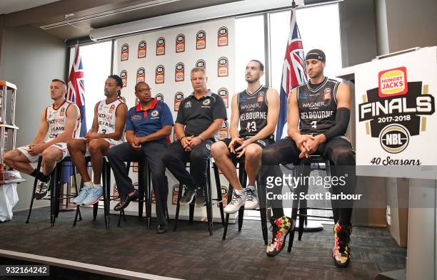 Coach Dean Vickerman, Josh Boone and Chris Goulding of Melbourne United along with Mitch Creek, Josh Childress and coach Joey Wright of the Adelaide...
