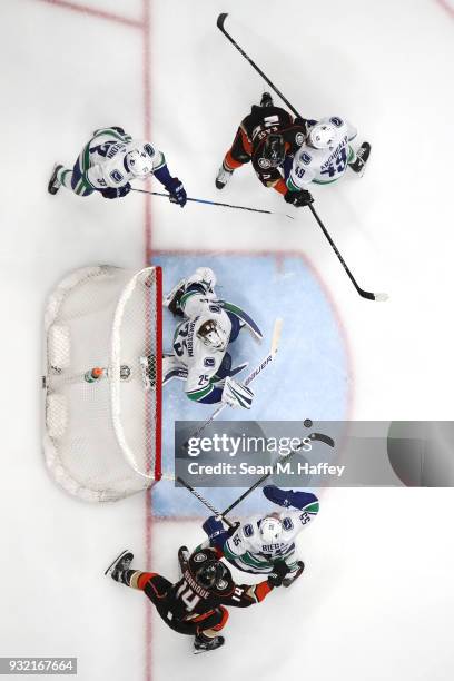 Darren Archibald, Henrik Sedin Jacob Markstrom and Alex Biega of the Vancouver Canucks defend against Adam Henrique and Ondrej Kase of the Anaheim...