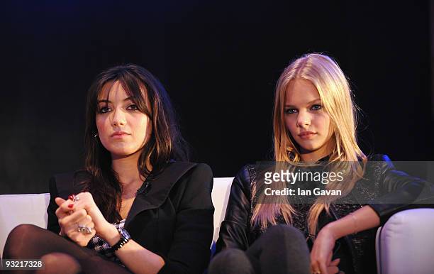 Daisy Lowe and Meloes Horst watch a presentation during the 2010 Pirelli Calendar Launch press conference at the Intercontinental Hotel, Park Lane on...