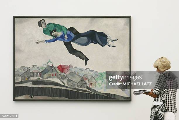 Journalist takes notes while looking at the painting "Over the City's roofs" by the Russian-French painter Marc Chagall at the Frieder Burda museum...