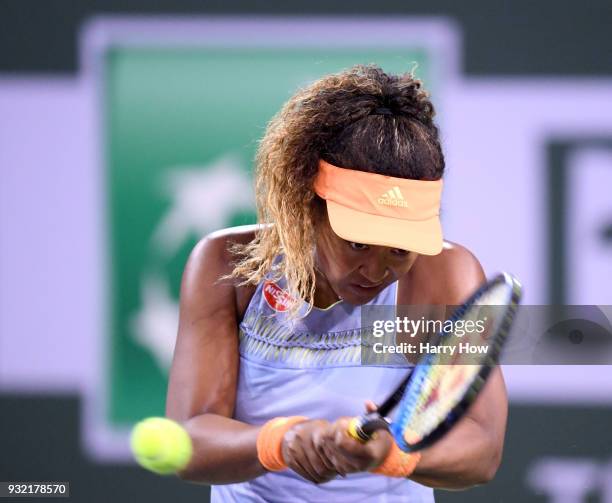 Naomi Osaka of Japan returns a backhand in her match against Karolina Pliskova of the Czech Republic during the BNP Paribas Open at the Indian Wells...