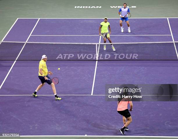 John Isner of the United States watches the ball sail out with partner jack Sock of the United States in their match against Ivan Dodig of Croatia...