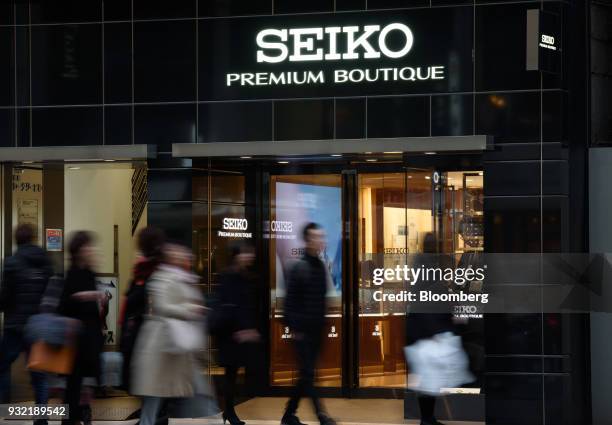 Pedestrians walk past the Seiko Premium Boutique store, operated by Seiko Watch Corp., in the Ginza district of Tokyo, Japan, on Wednesday, Feb. 28,...