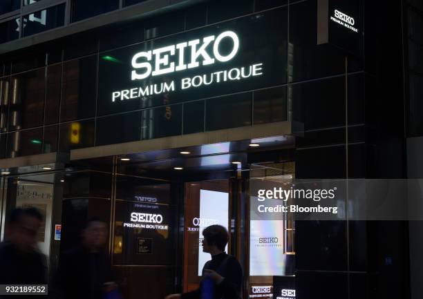 Pedestrians walk past the Seiko Premium Boutique store, operated by Seiko Watch Corp., in the Ginza district of Tokyo, Japan, on Wednesday, Feb. 28,...