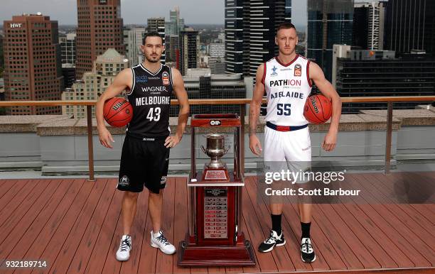 Chris Goulding of Melbourne United and Mitch Creek of the Adelaide 36ers pose with the Dr John Raschke Trophy during the NBL Grand Final media...