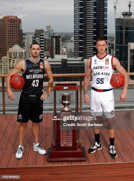 Chris Goulding of Melbourne United and Mitch Creek of the Adelaide 36ers pose with the Dr John Raschke Trophy during the NBL Grand Final media...