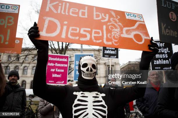 Protesters show banners during a bicycles protest against the ongoing diesel affair in front of the Transport Ministry on the day new Transport...