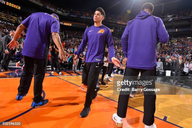 Devin Booker of the Phoenix Suns gets introduced before the game against the Cleveland Cavaliers on March 13, 2018 at Talking Stick Resort Arena in...