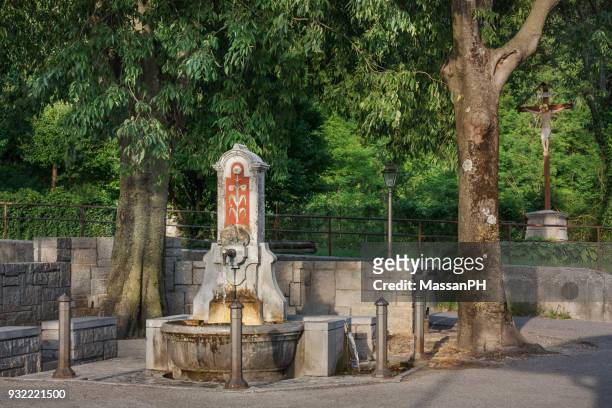 an ancient public fountain of pre-roman origin called silans or ad silanos in gemona del friuli - gemona del friuli stock pictures, royalty-free photos & images