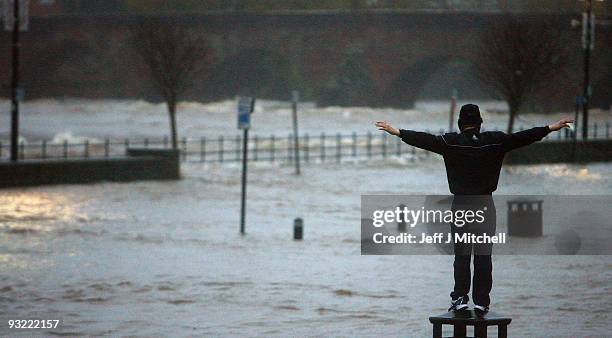 Member of the public views the flooding as the river Nith bursts, at the whitesands on November 19, 2009 in Dumfries, Scotland. Much of south west...