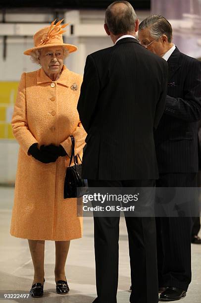 Queen Elizabeth II meets members of staff as she tours the Marshall Aerospace factory on November 19, 2009 in Cambridge, England. The privately-owned...