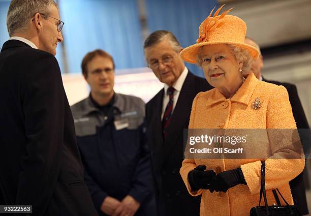 Elizabeth II meets members of staff as she tours the Marshall Aerospace factory on November 19, 2009 in Cambridge, England. The privately-owned...