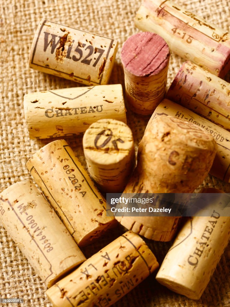 Assorted wine corks on hessian background