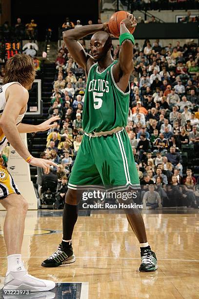 Kevin Garnett of the Boston Celtics moves the ball against Josh McRoberts of the Indiana Pacers during the game on November 14, 2009 at Conseco...