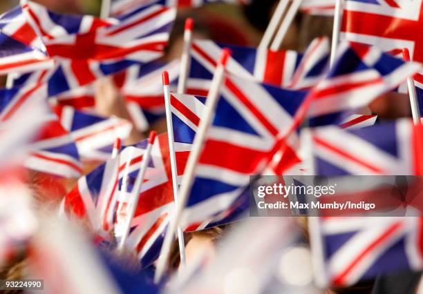 School children wave Union Jack flags as HM Queen Elizabeth II attends the 900th anniversary celebrations of the Diocese of Ely at Ely Cathedral on...