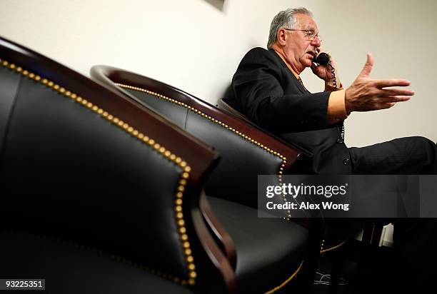 Chairman of the FreedomWorks and former U.S. House Majority Leader Dick Armey talks on the phone as he waits in a holding room for his turn to...