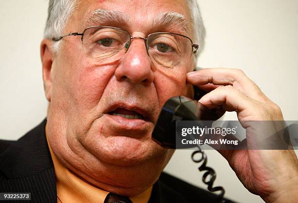 Chairman of the FreedomWorks and former U.S. House Majority Leader Dick Armey talks on the phone as he waits in a holding room for his turn to...