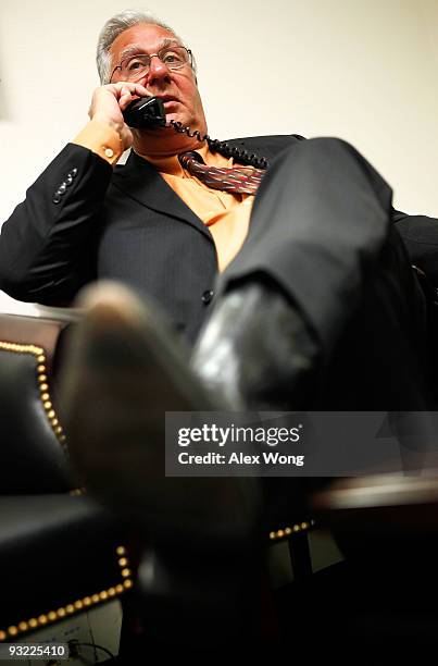 Chairman of the FreedomWorks and former U.S. House Majority Leader Dick Armey talks on the phone as he waits in a holding room for his turn to...