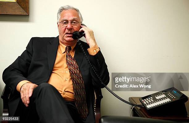 Chairman of the FreedomWorks and former U.S. House Majority Leader Dick Armey talks on the phone as he waits in a holding room for his turn to...